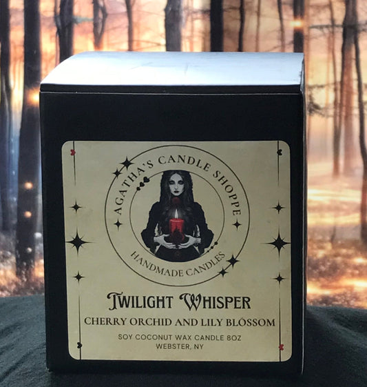 Soy gothic, witchy candle in a box labeled, "Twilight Whisper" for a scent of cherry and lily background in a forrest with magical, mystical twinkle lights