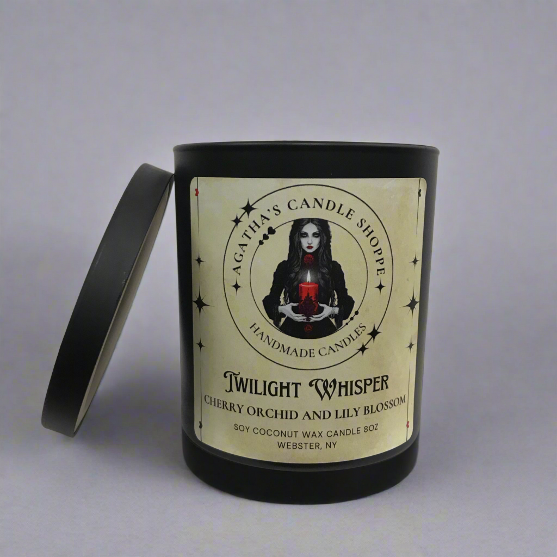 Soy candle labeled, Twilight Whisper, lid off with a witchy, gothic vibe