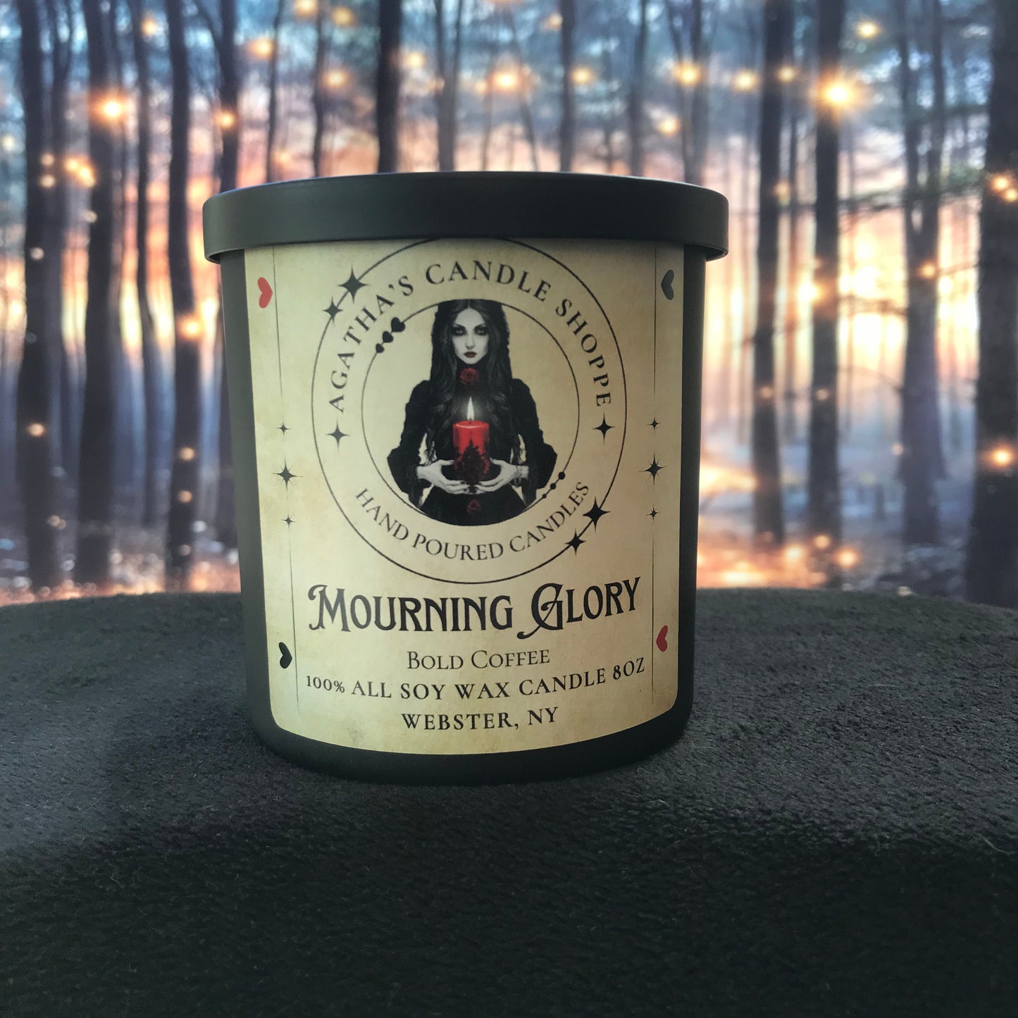 Dark gothic soy candle titled “Mourning Glory,” evoking dawn and quiet grief, with rich coffee-inspired warmth and a somber, reflective atmosphere drawn from Agatha’s diary pages.