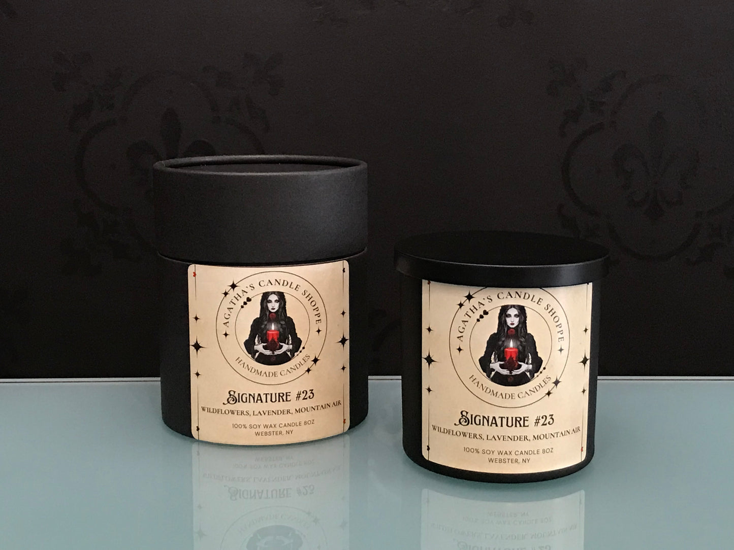 Agatha’s Signature Series candle “23,” a scent, surrounded by wildflowers and sprigs of lavender, evoking mystery, new love, and a hidden story whispered from forgotten pages.