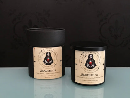 Agatha’s Signature Series candle “23,” a scent, surrounded by wildflowers and sprigs of lavender, evoking mystery, new love, and a hidden story whispered from forgotten pages.