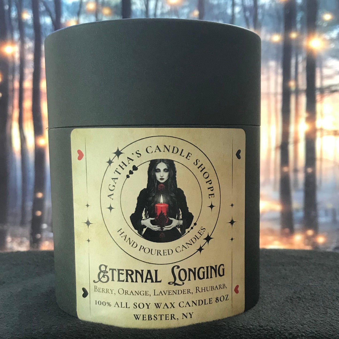 Candle in its packaging, labeled Eternal Longing, with scent of Berry Orange, Lavender and rhubarb. 8oz all soy way candle.